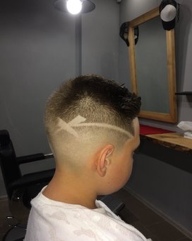 Children's haircuts with a pattern on the head at the KINGS MAN barbershop in Zaporozhye. Sign up for the promotion.